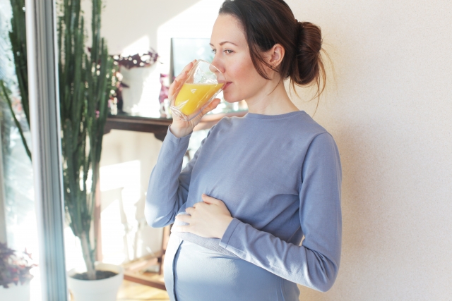 妊婦がスムージーを飲んでいる画像